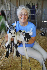 Jennifer holding two baby goats 