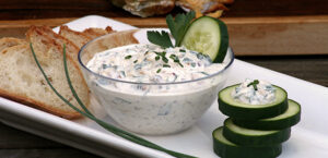Bowl of smoked trout spread with cucumber