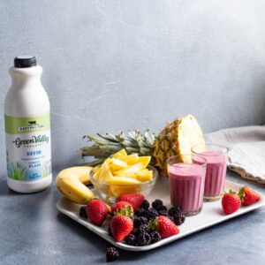 Plain Kefir and a plate with fruit and two glasses of smoothies 