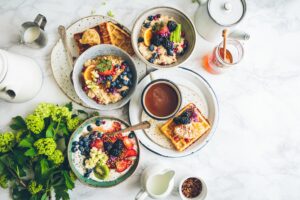 Breakfast spread with bowls of oatmeal and waffles