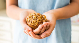 Person holding apple muffin 