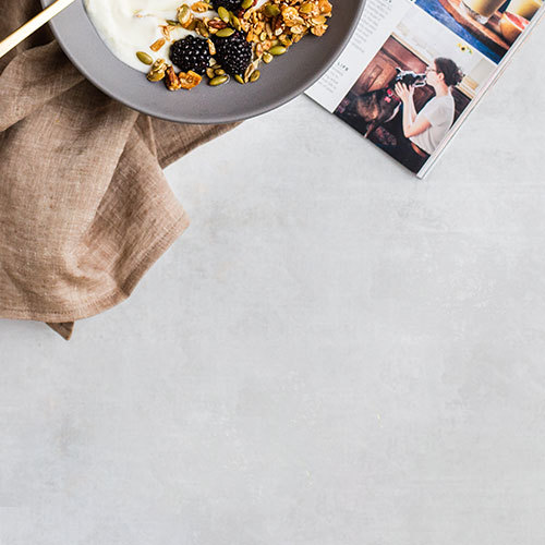 yogurt with granola ad berries on top of a magazine